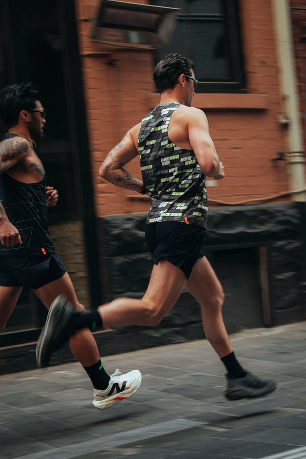 Male athlete running in Bricks Singlet – performance running top by NVR.RUN